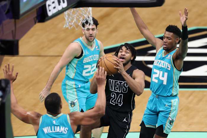  Brooklyn Nets guard Cam Thomas (24) go ups for a layup against Charlotte Hornets forward Brandon Miller (24) during the second quarter at Spectrum Center.